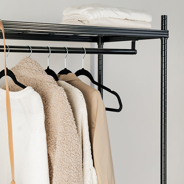 Black velvet coat hangers for wardrobe organisation and home organisation services, keeping NZ closets neat and tidy.