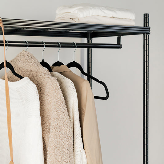 Black velvet coat hangers for wardrobe organisation and home organisation services, keeping NZ closets neat and tidy.