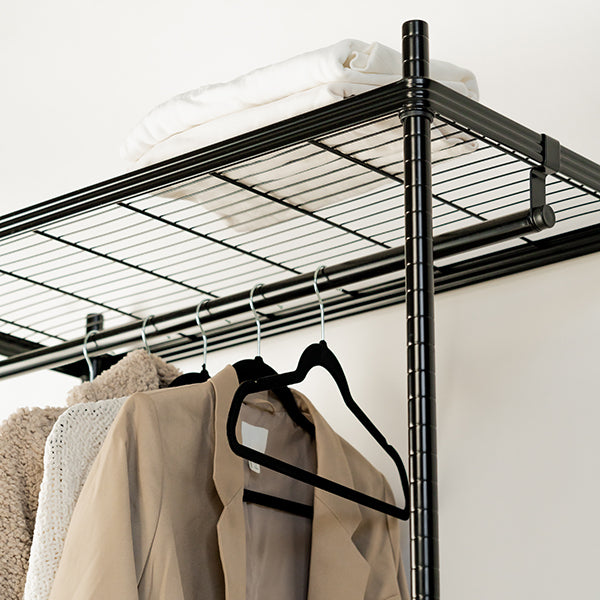 Black velvet coat hangers for wardrobe organisation and home organisation services, keeping NZ closets neat and tidy.