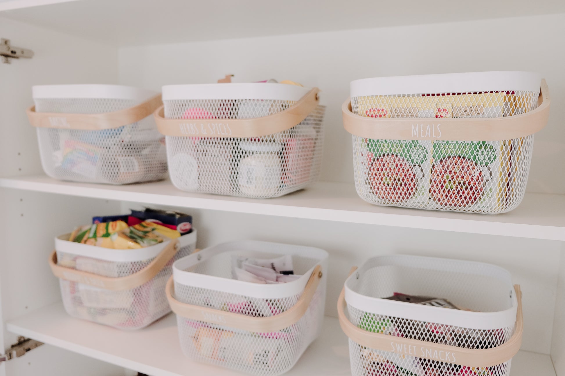 Set of stylish wire storage baskets with natural bamboo handles, perfect for organising pantry, laundry, or home essentials.