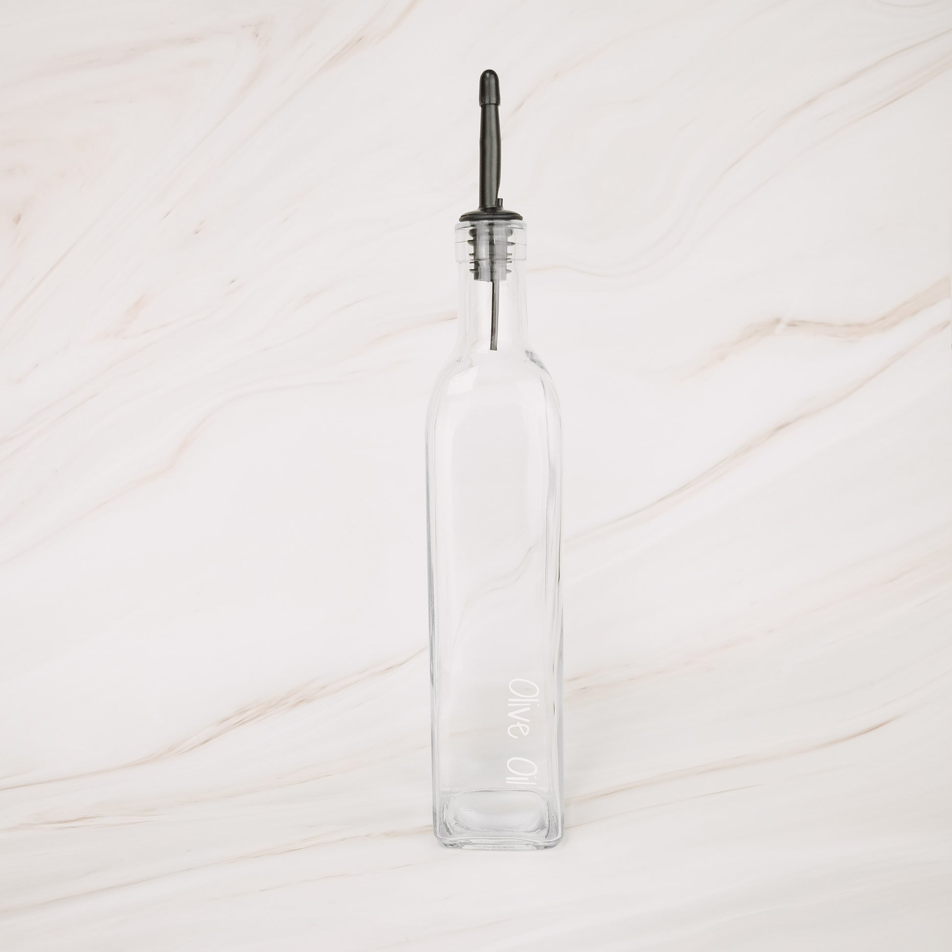 Glass oil bottle with black plastic pourer, perfect for kitchen storage and pantry organisation in NZ homes.