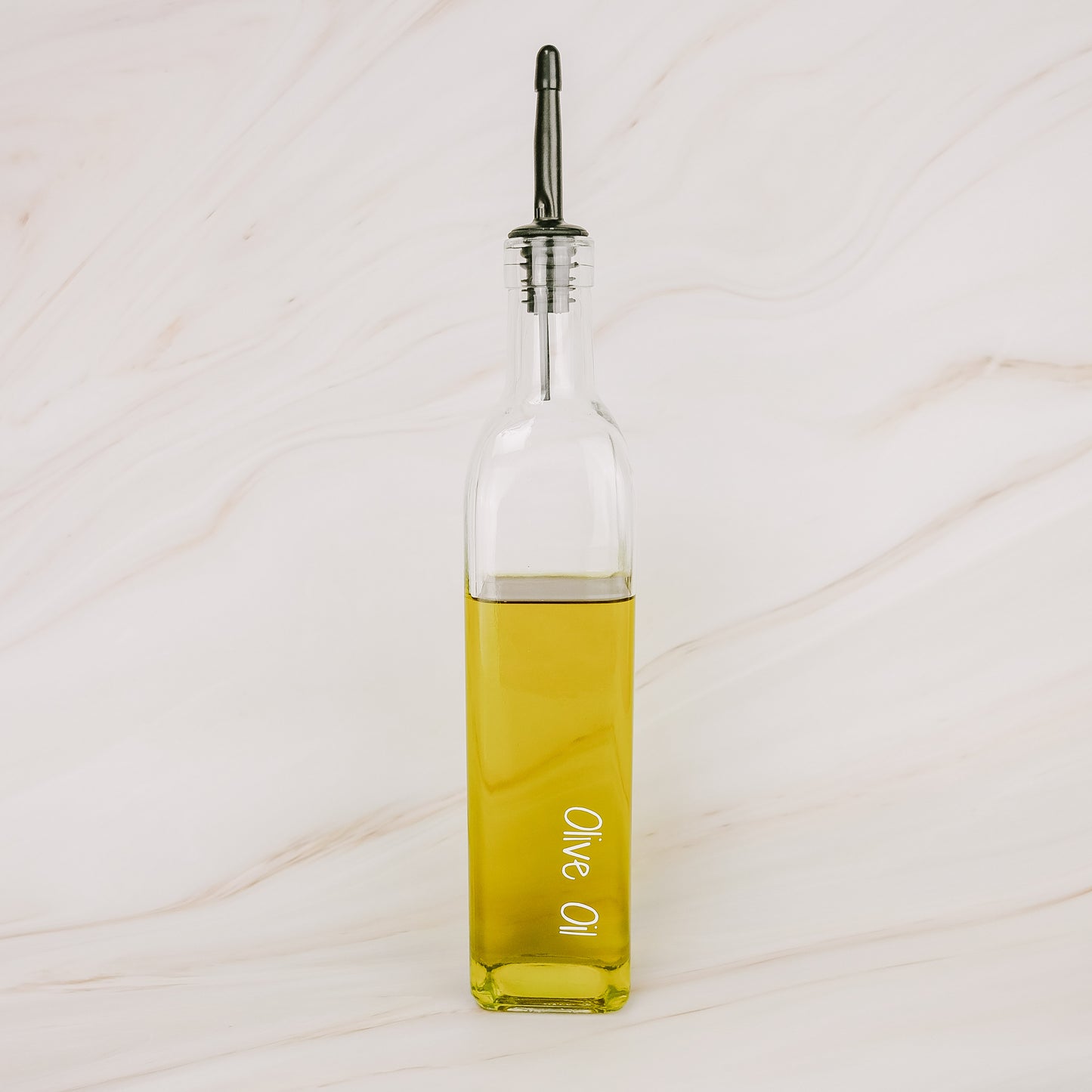 Glass oil bottle with black plastic pourer, ideal for pantry organisation, kitchen storage, and home organisation services NZ.