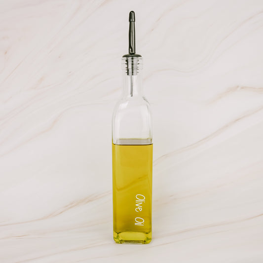 Glass oil bottle with black plastic pourer, ideal for pantry organisation, kitchen storage, and home organisation services NZ.