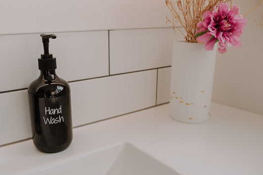 Black plastic liquid dispenser, perfect for kitchen storage and organising soaps or syrups in NZ homes.