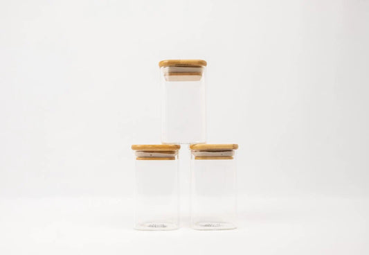 Square glass spice jars with bamboo lids, ideal for pantry organisation, kitchen storage, and decluttering services NZ.