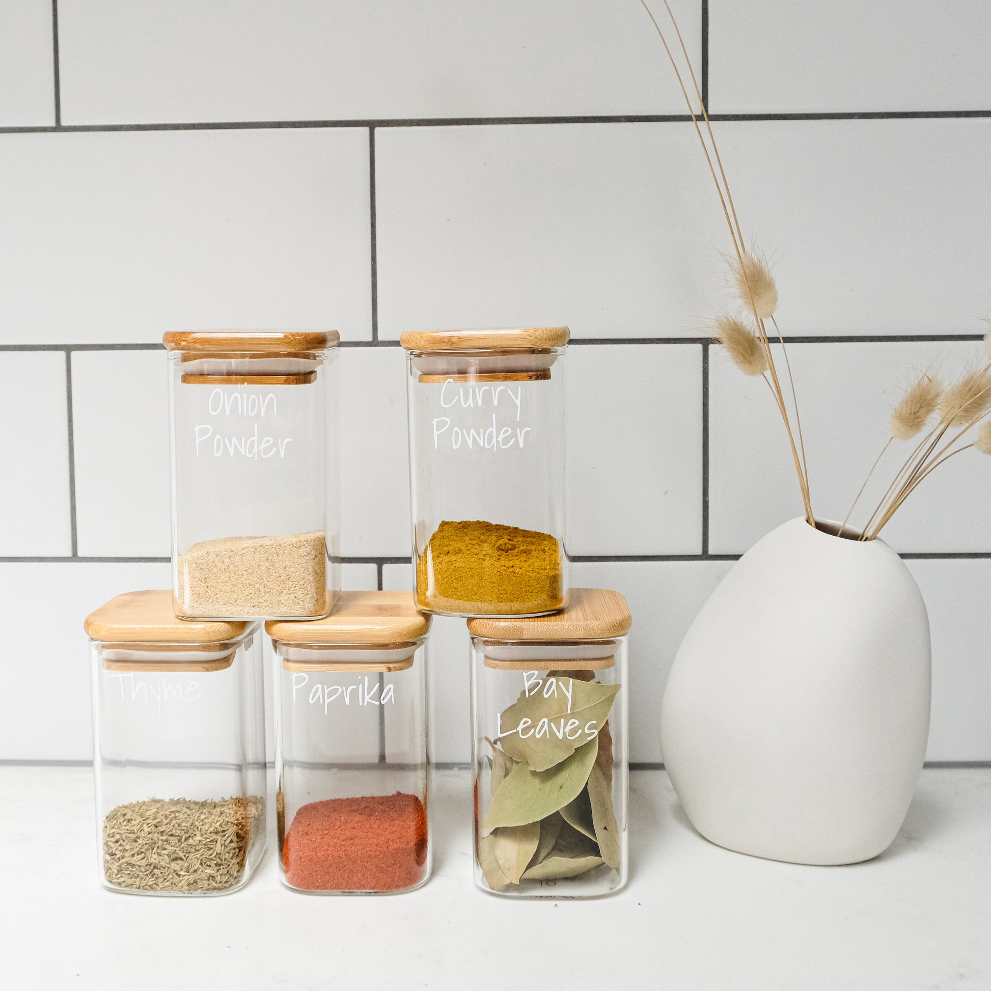 Square glass spice jars with bamboo lids, perfect for pantry organisation, kitchen storage, and home organisation services NZ.