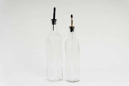 Glass oil bottles with black plastic pourers, ideal for kitchen storage and pantry organisation in NZ.