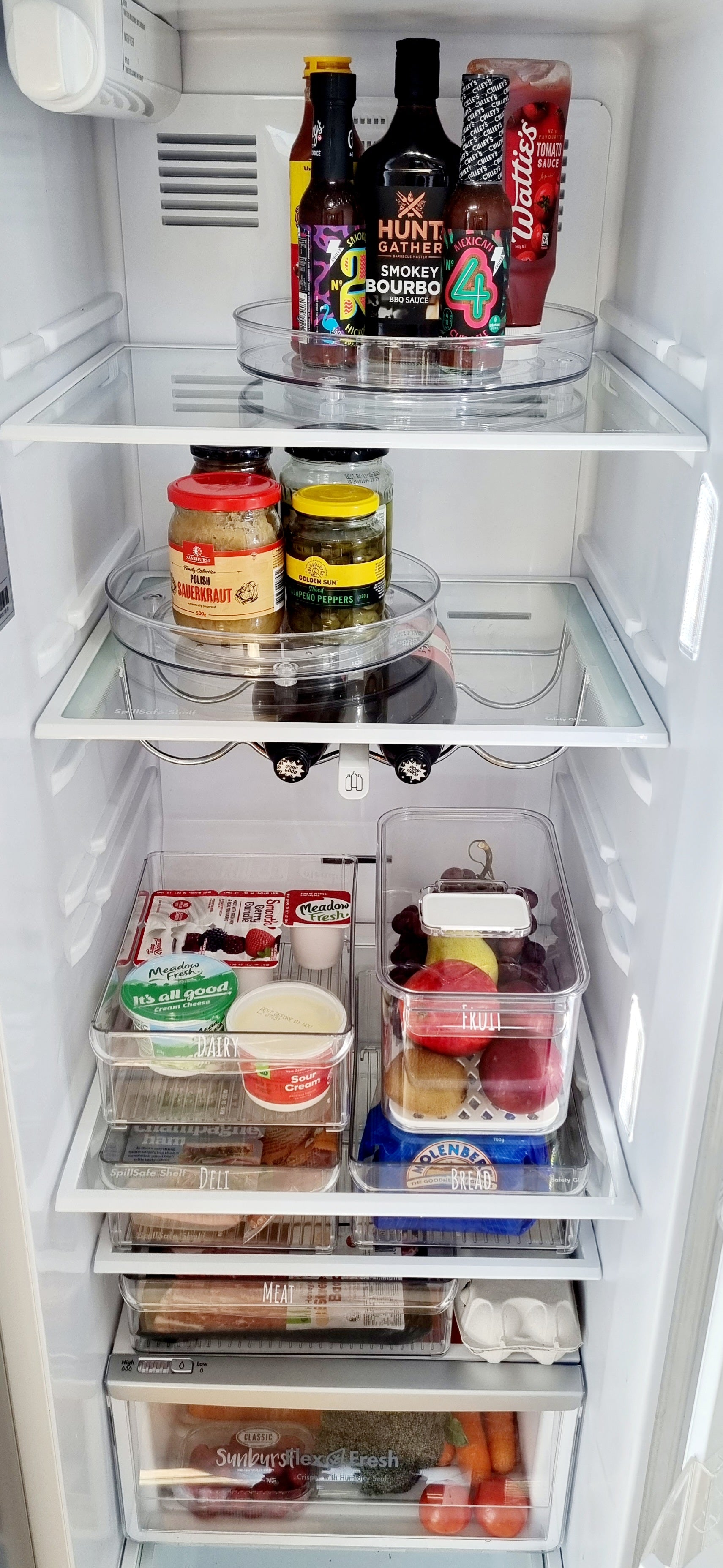 Organised fridge featuring storage containers NZ and fridge organisation solutions for tidy and efficient NZ homes.
