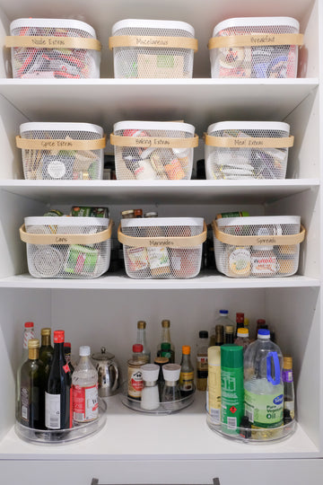 Organised pantry with wire baskets and bamboo handles plus turntables – ideal for kitchen storage and pantry organisation.
