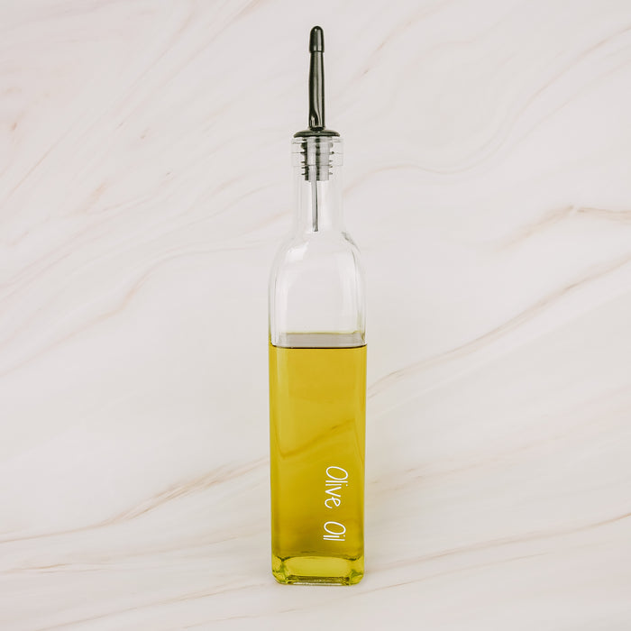 Glass oil bottle with black plastic pourer, ideal for pantry organisation, kitchen storage, and home organisation services NZ.
