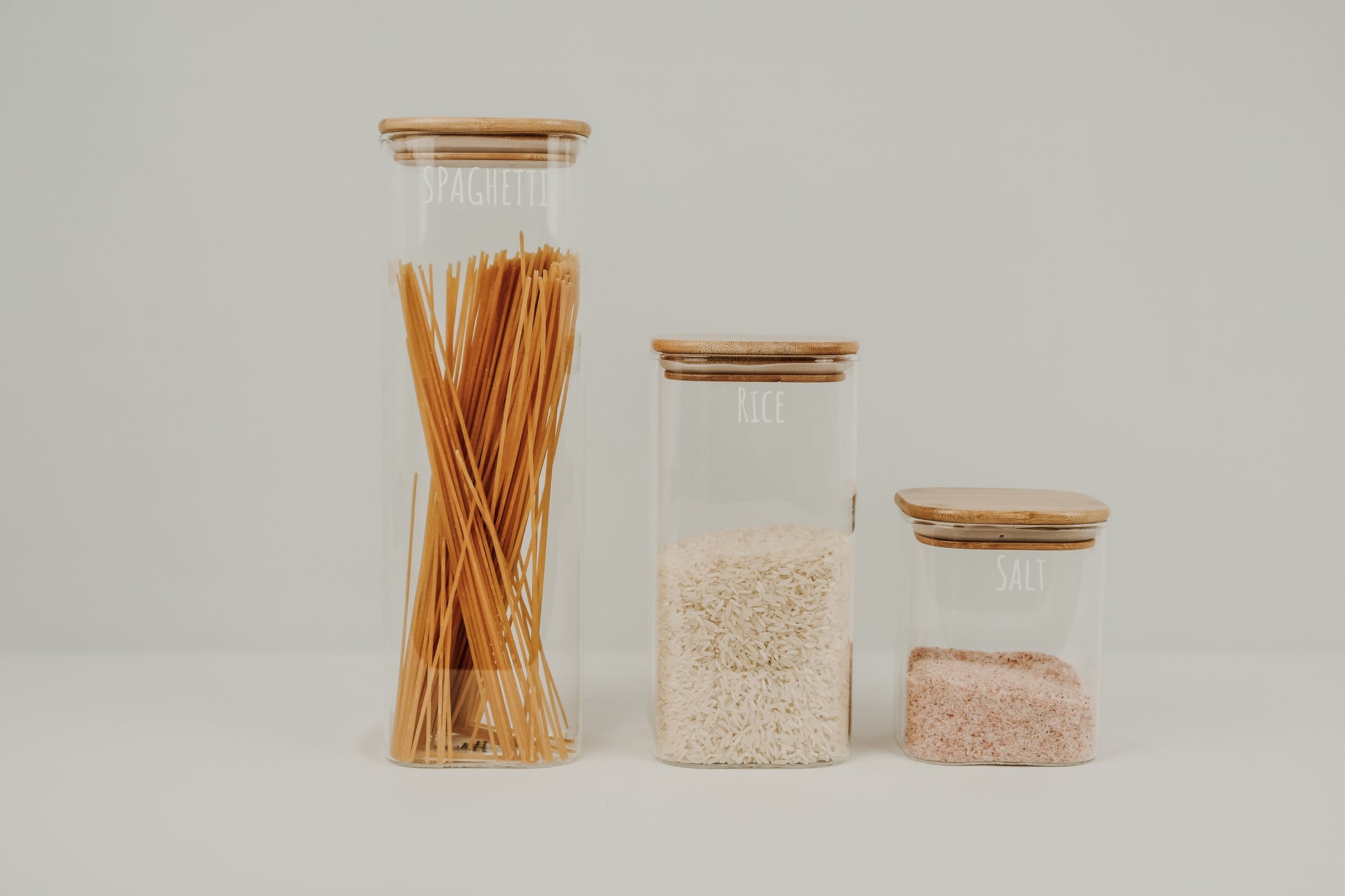 Square glass containers with bamboo lids, ideal for pantry organisation, kitchen storage containers NZ.
