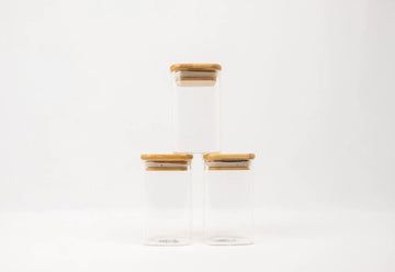 Square glass spice jars with bamboo lids, ideal for pantry organisation, kitchen storage, and decluttering services NZ.