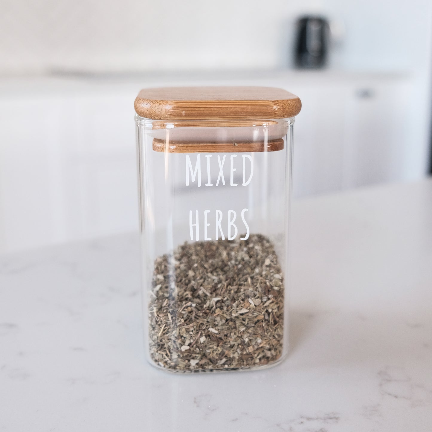 Square glass spice jars with bamboo lids, perfect for organised kitchen storage and pantry organisation in NZ.