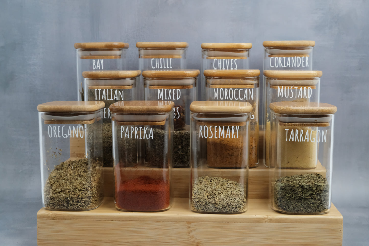 Organised glass spice jars on a bamboo spice rack, perfect for pantry organisation and kitchen storage in NZ homes.
