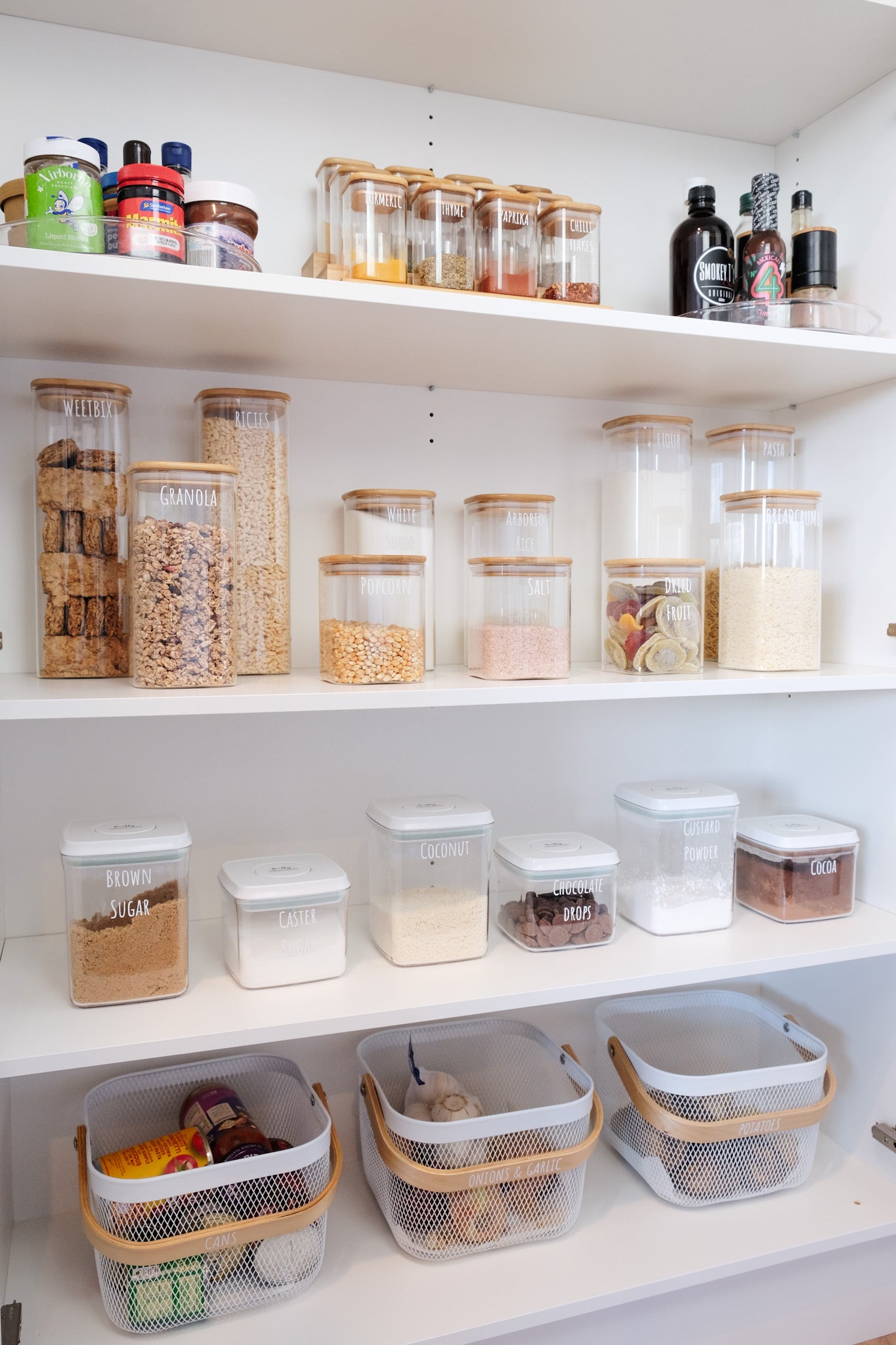 Neatly organised pantry featuring Pretty Pantry Sets with airtight containers NZ and glass containers NZ displayed.
