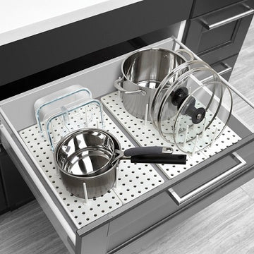 Pots and pans on a pegboard in a kitchen drawer