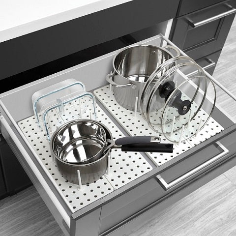 Pots and pans on a pegboard in a kitchen drawer